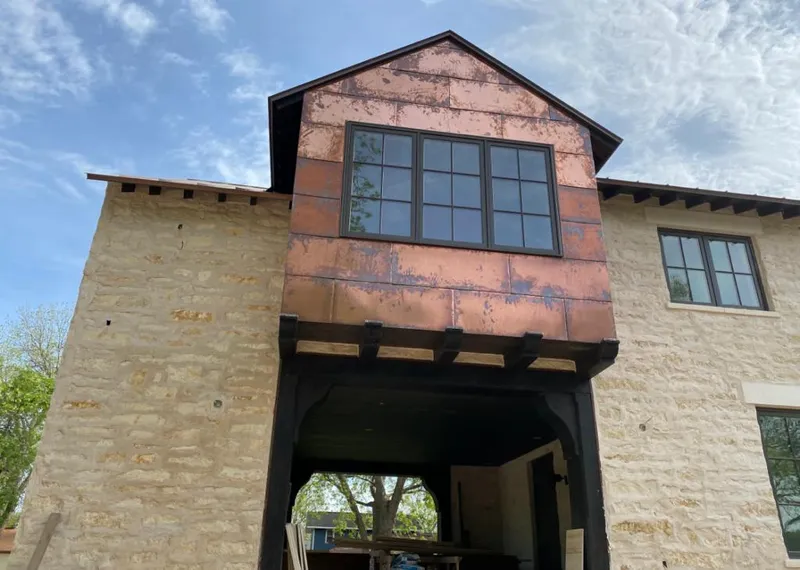 Copper metal panel facade on a stone building for Skylight Installation in Pasco
