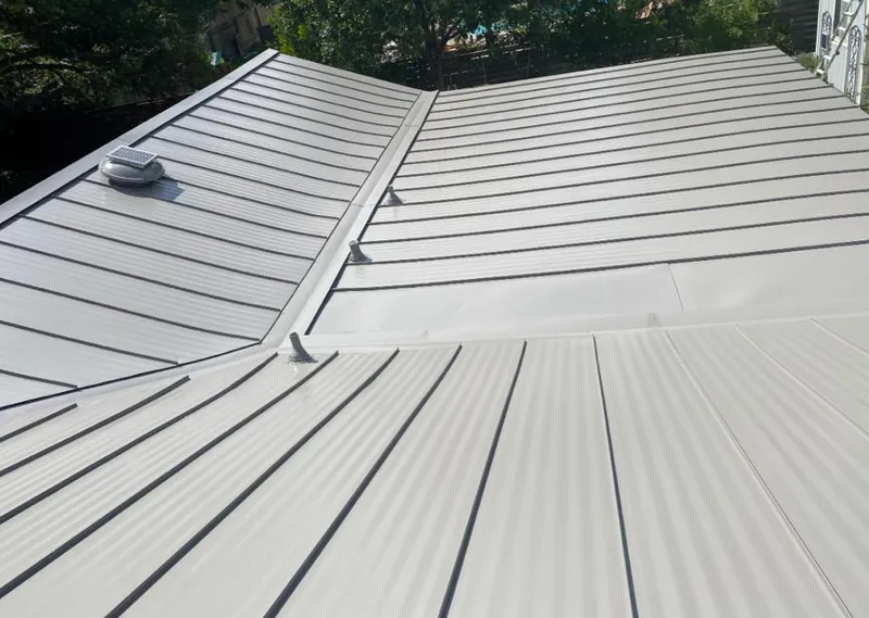 Solar attic fan installed on a metal roof for Roof Ventilation in Pasco